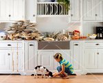 70308643-Plates-piled-high-on-counter-top-after-a-dinner-with-girl-feeding-leftovers-to-dog.jpg